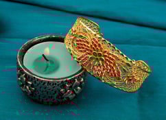 Delicate gold arm cuff with ruby and emerald colored accents Delicate gold arm cuff with ruby and emerald colored accents